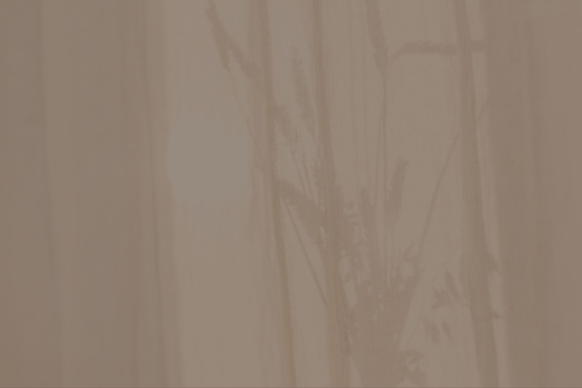 A brown banner sitting behind the Design Curtains mission statement of "Giving kiwis the confidence and ease to purchase their custom curtains and blinds online."