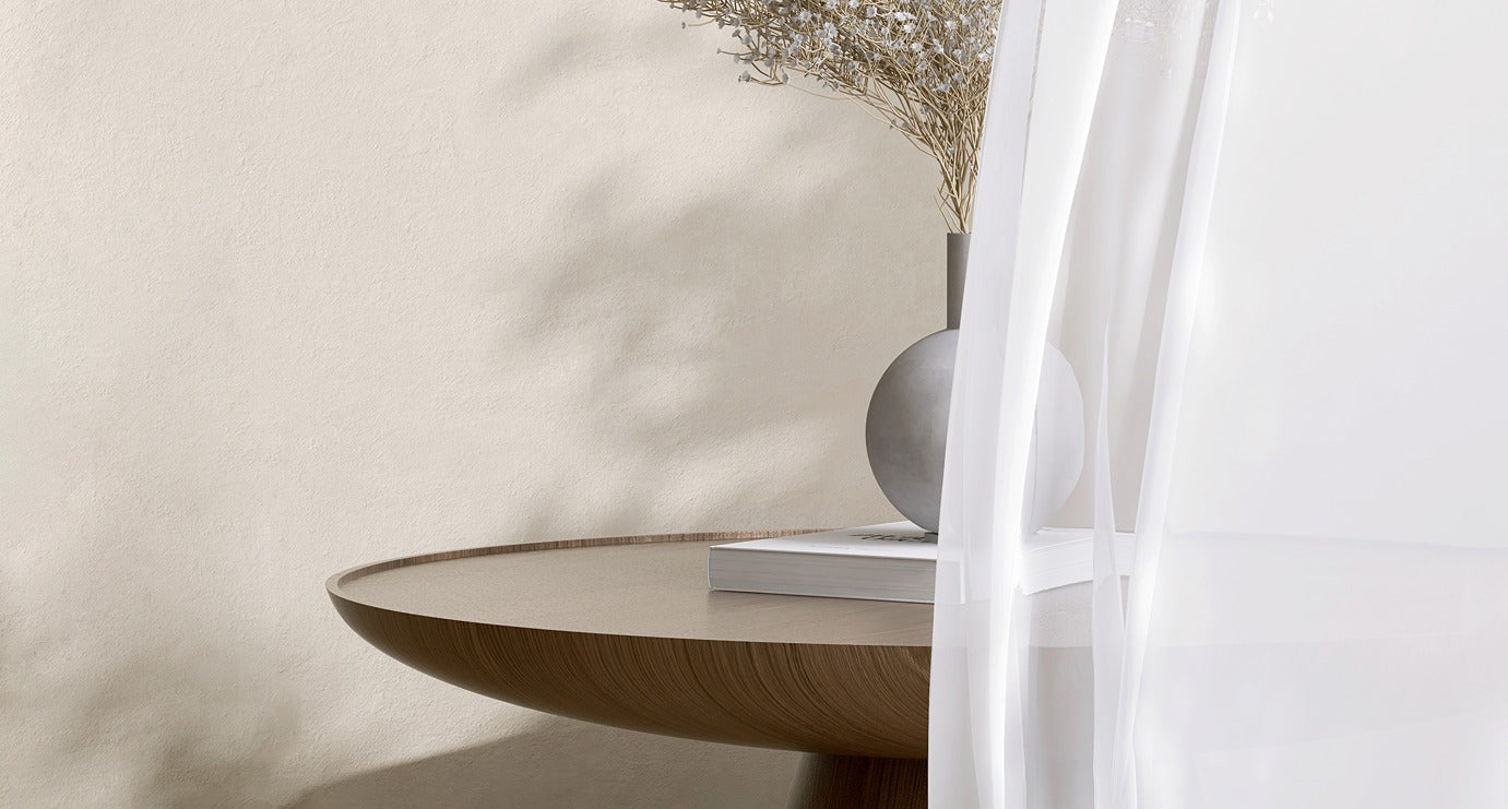 Sheers caress the edge of a circular timber table. Part of the offering of custom curtains & blinds experts - Design Curtains.