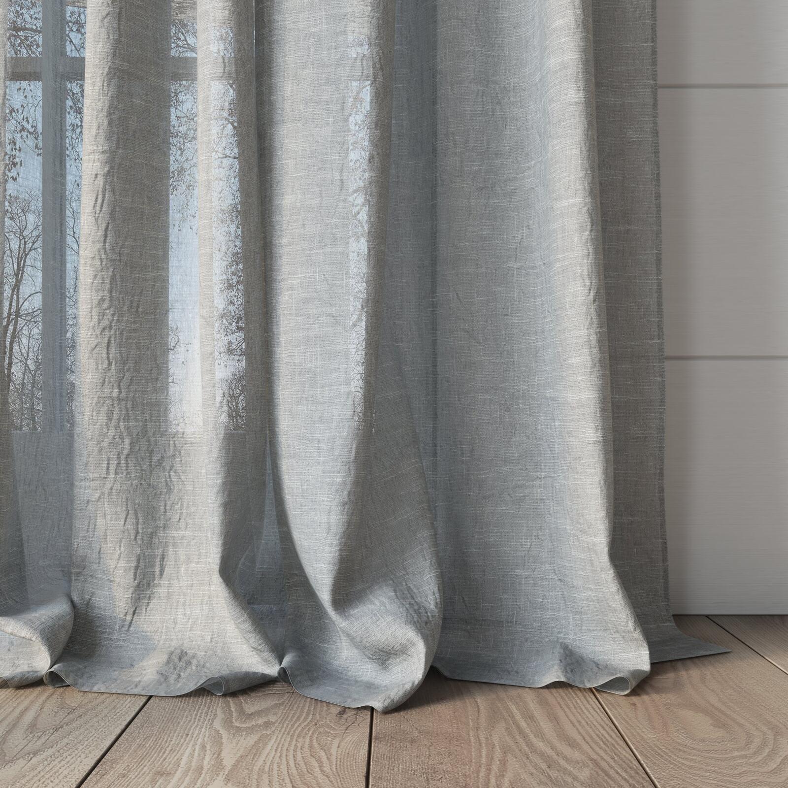 The hem of Lattice ash semi-transparent curtains gracefully cascading onto a timber floor.