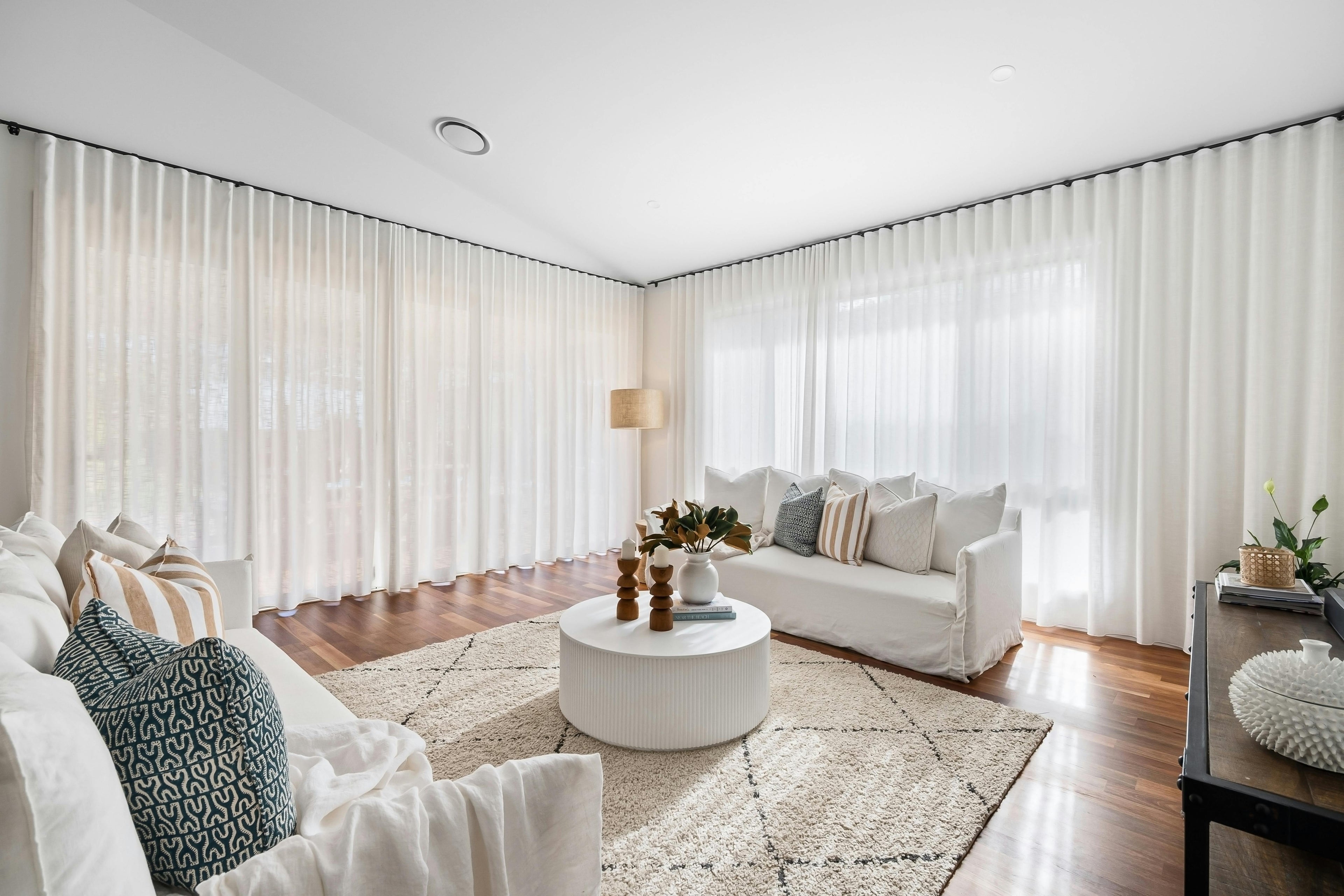 A stunning, spacious living room featuring curtains by Design Curtains, achieved via online curtain consultation.