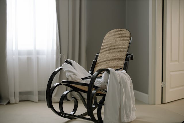 Custom curtains & blinds draped over a chair to depict the story of Design Curtains.