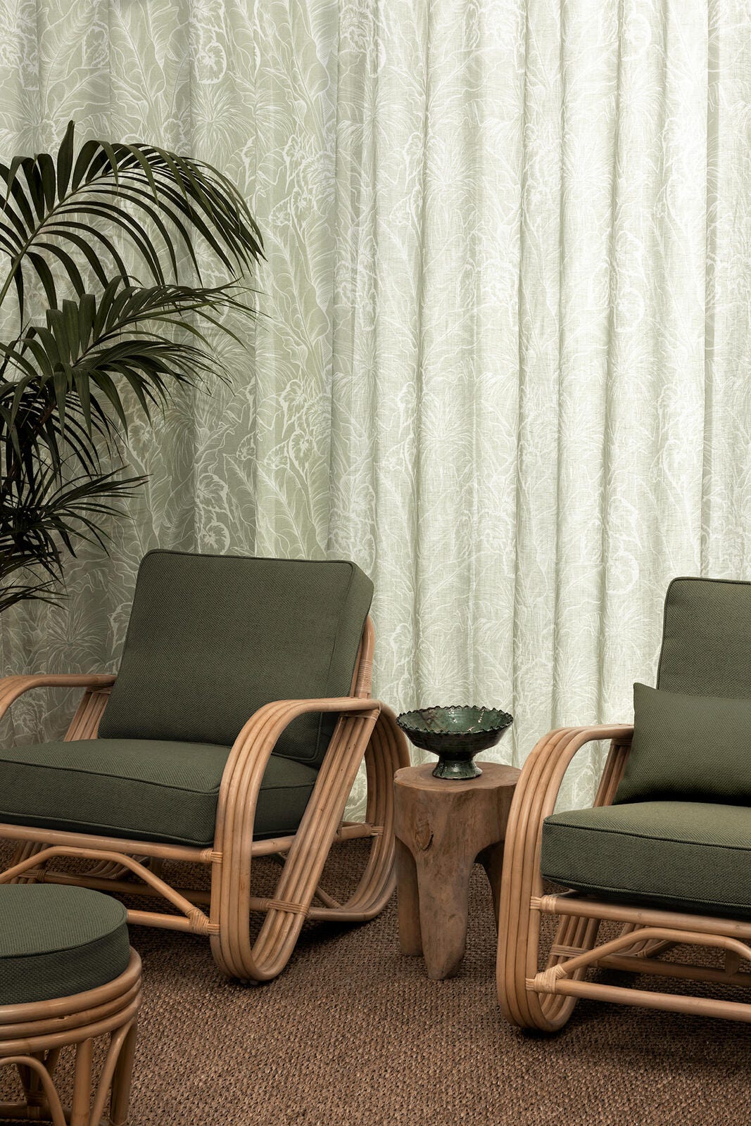 Palmery sage see-through sheer curtains by James Dunlop displayed in the sitting room of a home.